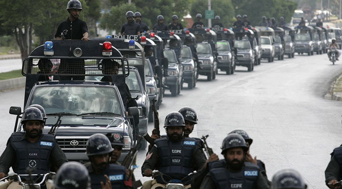 Pakistani police officers patrol the streets of Karachi